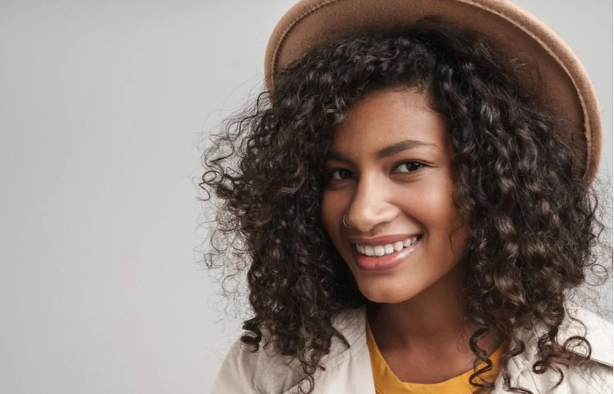 How To Style Curls Under a Hat and Prevent Dreaded Hat Hair