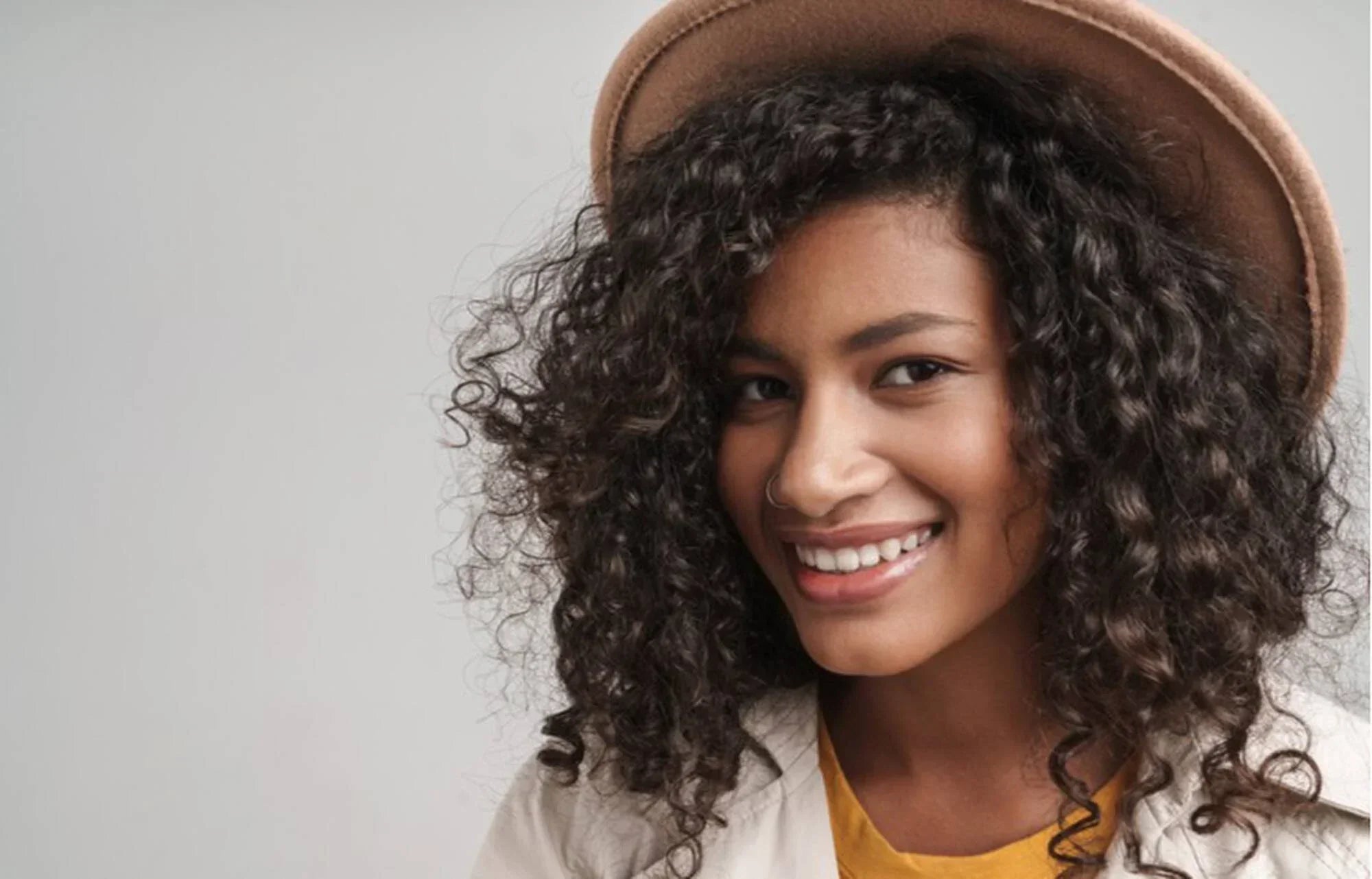 How to Style Curls Under a Hat and Prevent Hat Hair